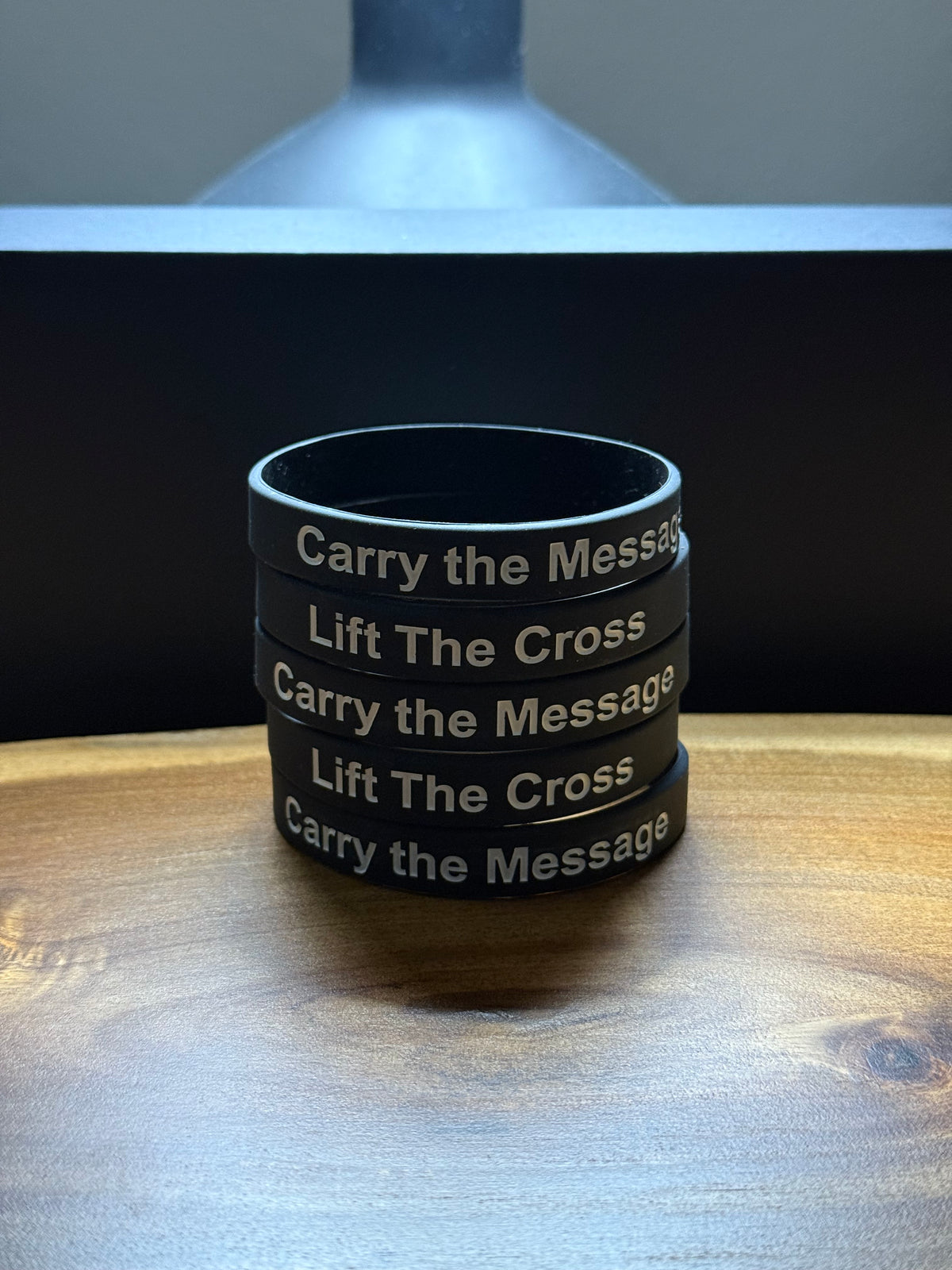 Black silicon wristbands with 'Carry the Message' and 'Lift The Cross' text stacked