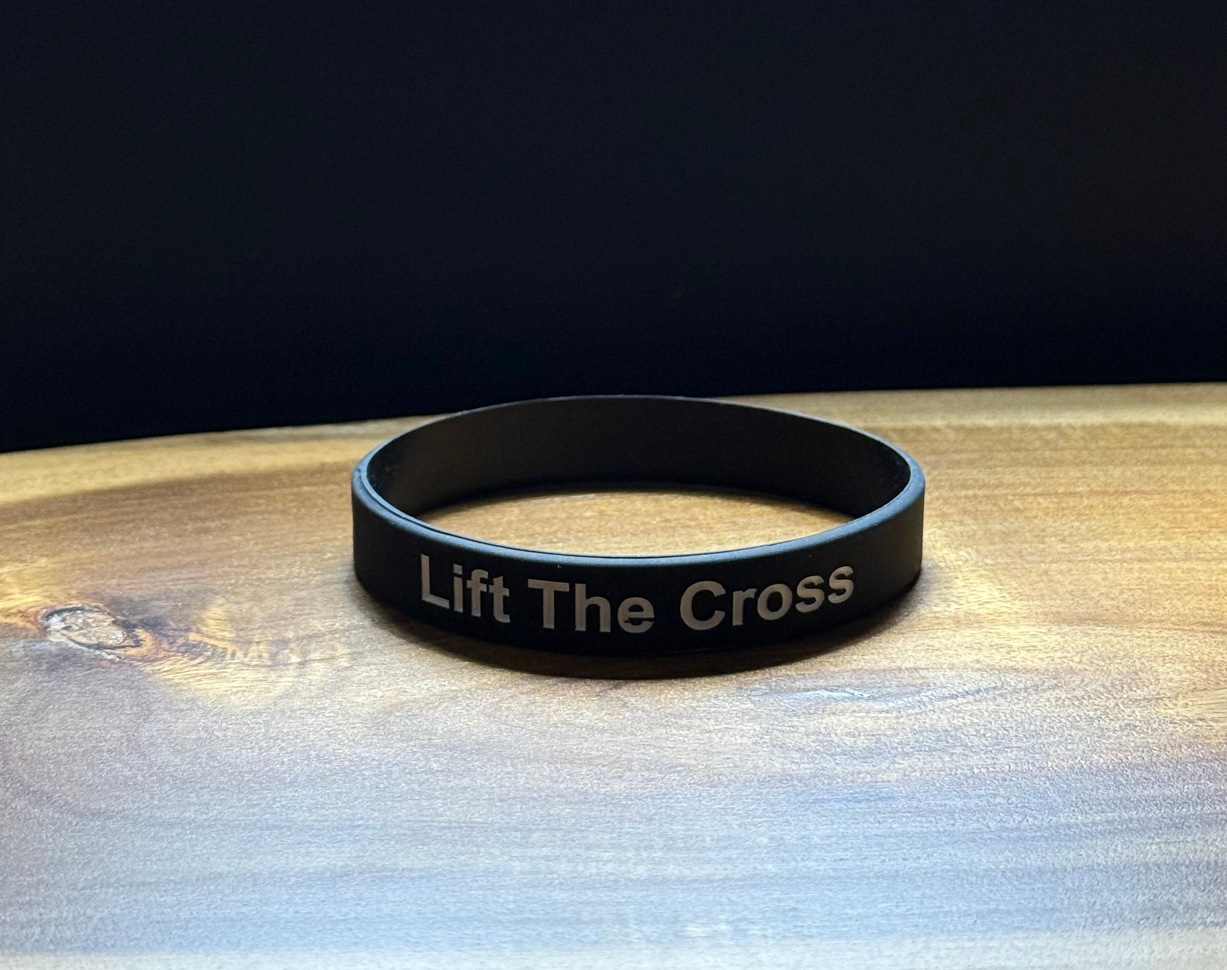 Black silicon wristband with 'Lift The Cross' text